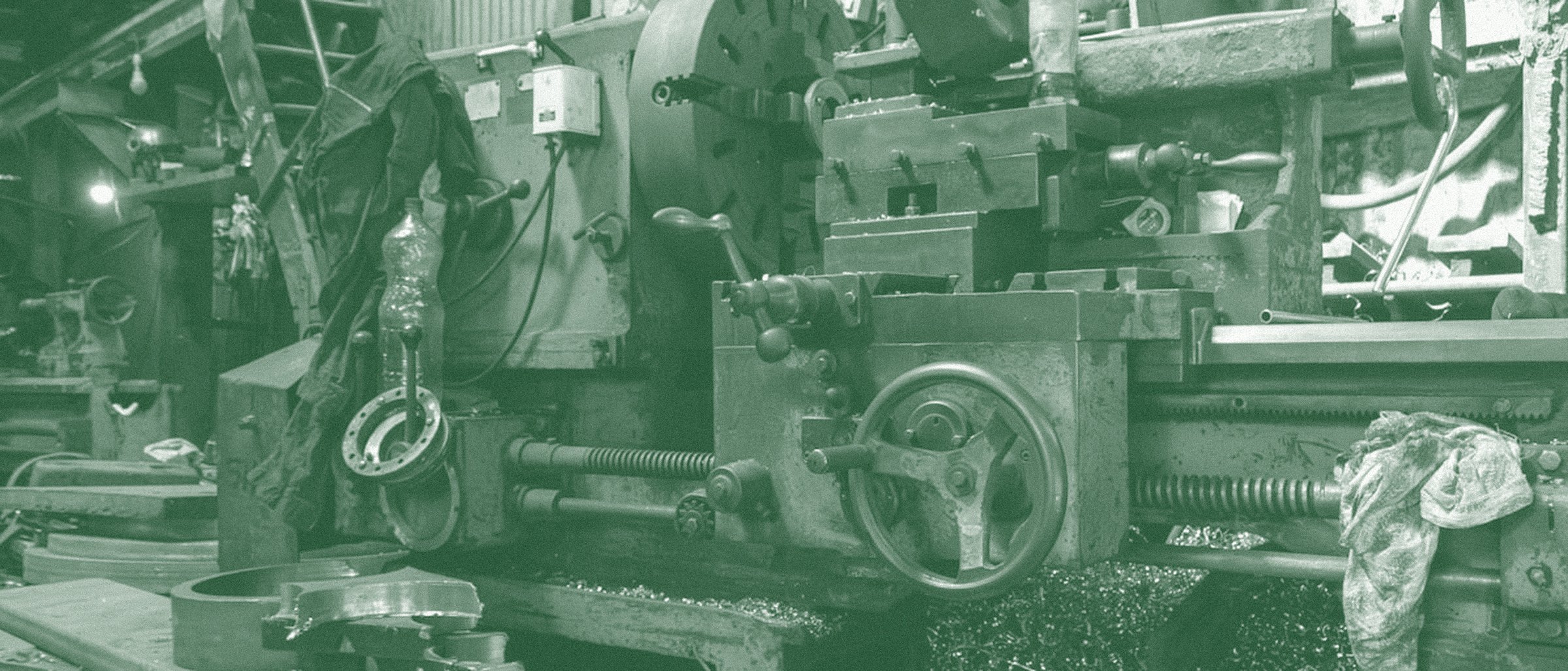 Interior of a metal fabrication shop with machinery and steel stock